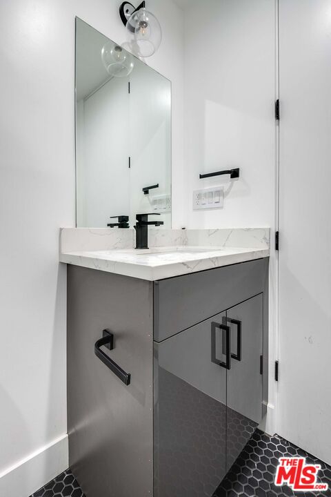 15330 Weddington Street Sherman Oaks, CA 91411 - Photo 19 of 30 a bathroom with a sink and a mirror