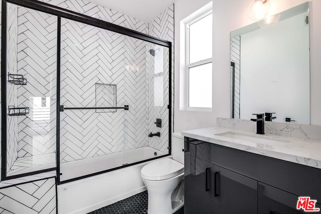 15330 Weddington Street Sherman Oaks, CA 91411 - Photo 24 of 30 a bathroom with a granite countertop sink mirror vanity and toilet
