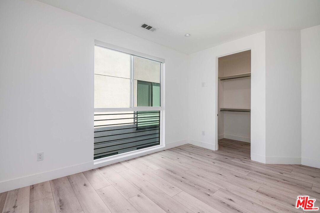 15330 Weddington Street Sherman Oaks, CA 91411 - Photo 25 of 30 a view of an empty room with wooden floor and a window