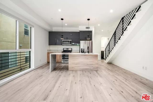 a view of kitchen with sink microwave and stove