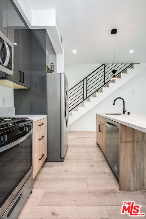 15330 Weddington Street Sherman Oaks, CA 91411 - Photo 10 of 30 a kitchen with stainless steel appliances granite countertop a sink a stove and a refrigerator
