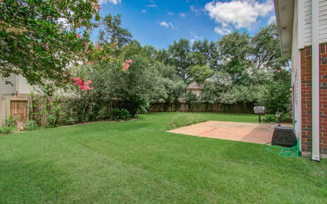 a view of yard with swimming pool and green space