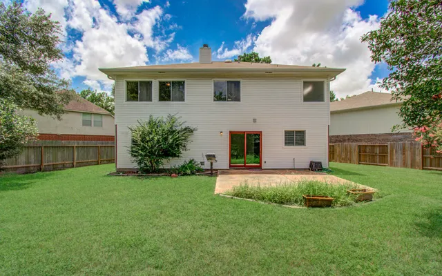 a front view of a house with a garden and yard