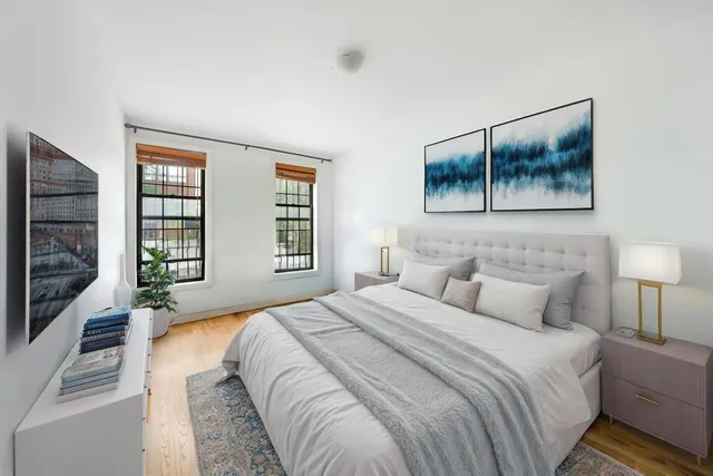 a bedroom with a bed and a window