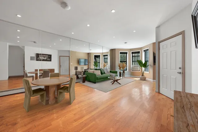 a view of a dining room with furniture window and wooden floor
