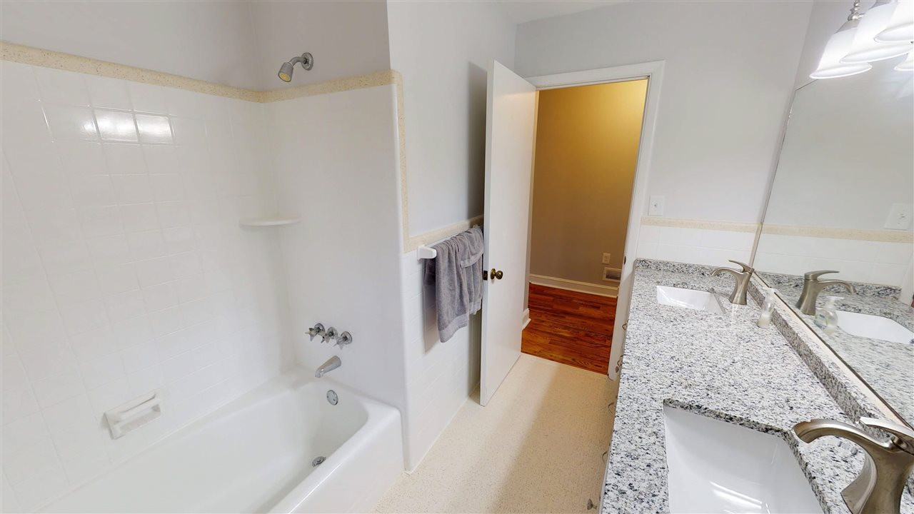 108 Rand Road Raleigh, NC 27603 - Photo 16 of 29 Tub has beautiful tile shower surround. Bathroom floor is tile too. 2nd Bathroom
