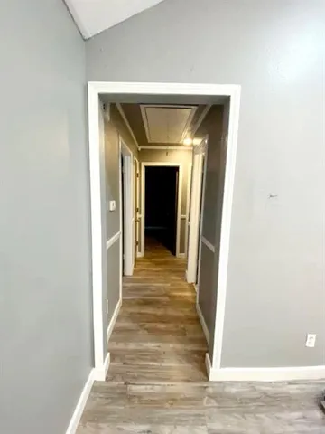 a view of a hallway view with wooden floor and staircase