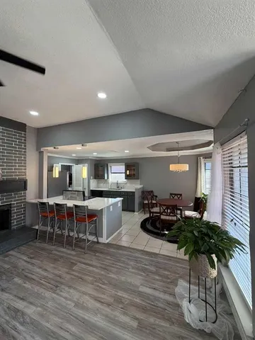 a living room with furniture wooden floor and a large window