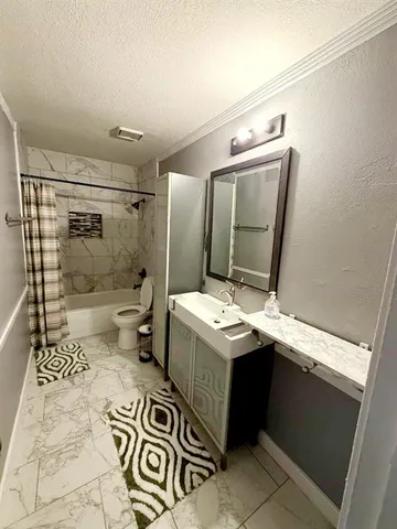 a bathroom with a sink and mirror with bathtub