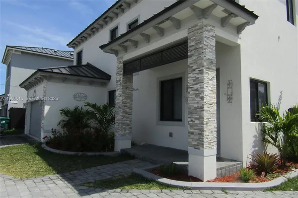 a front view of a house with garden
