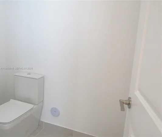 a white toilet sitting next to a shower