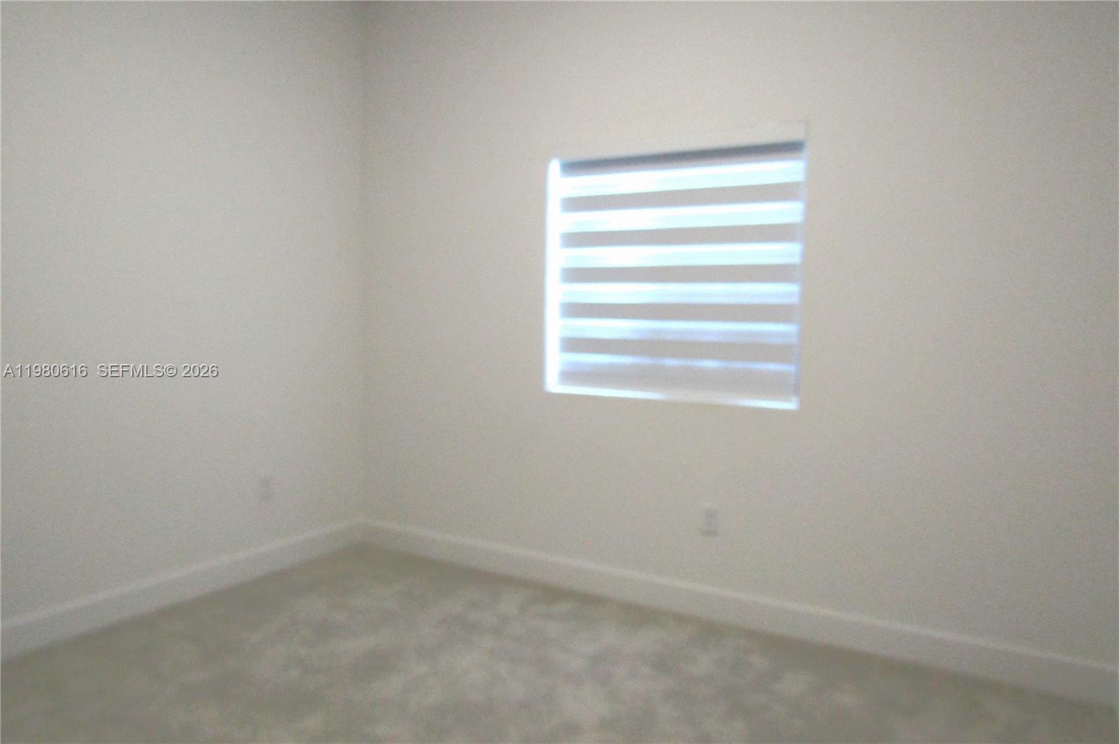 11998 Southwest 232nd Street Miami, FL 33170 - Photo 8 of 26 a room that has a window in it