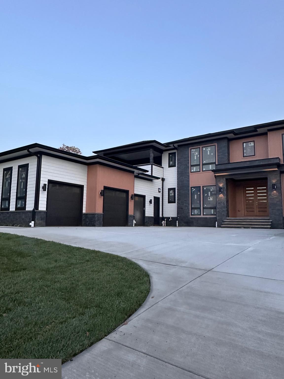2113 Chain Bridge Road Vienna, VA 22182 - Photo 5 of 8 a front view of a house with a yard and garage