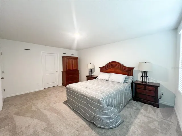 a bedroom with a bed and a night stand