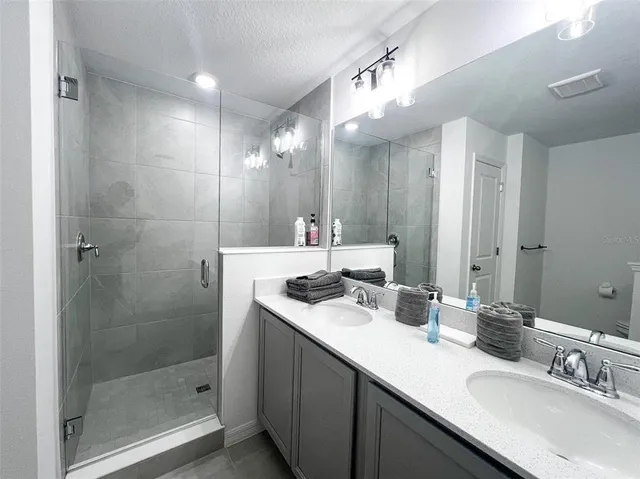 a bathroom with a sink double vanity and a shower