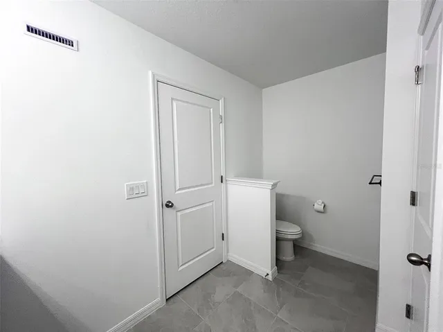 a white toilet sitting next to a bathroom sink