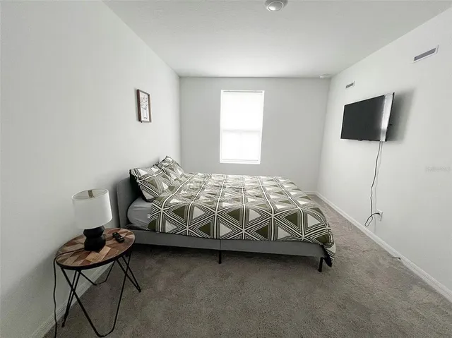 a bedroom with a bed and a tv