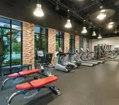 a room with gym equipment and a large window