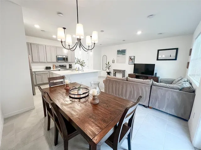 a kitchen with granite countertop white cabinets and stainless steel appliances