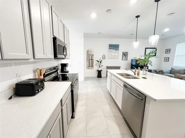 a kitchen with a sink a counter and cabinets