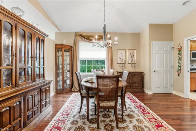 a view of a dining room with furniture and chandelier