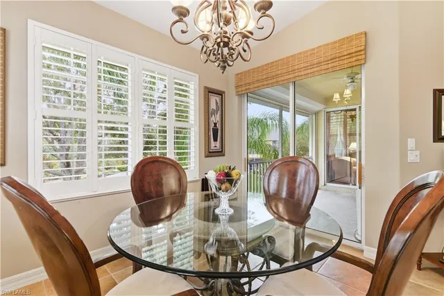 a view of a dining room with furniture wooden floor and a chandelier