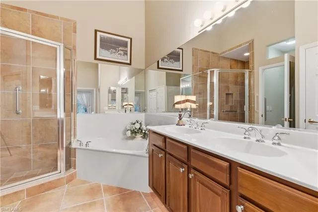 a spacious bathroom with a shower sink and mirror