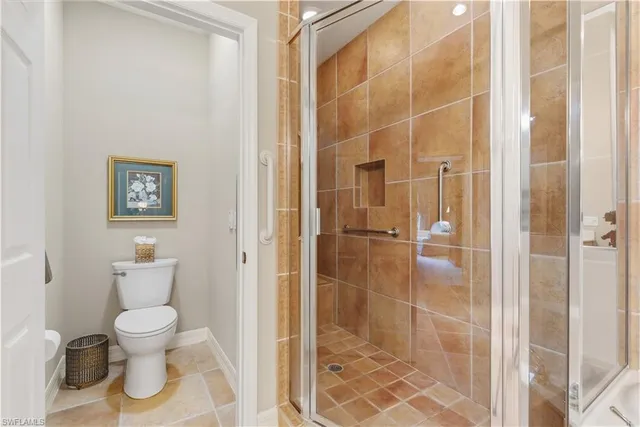 a bathroom with a toilet and a shower