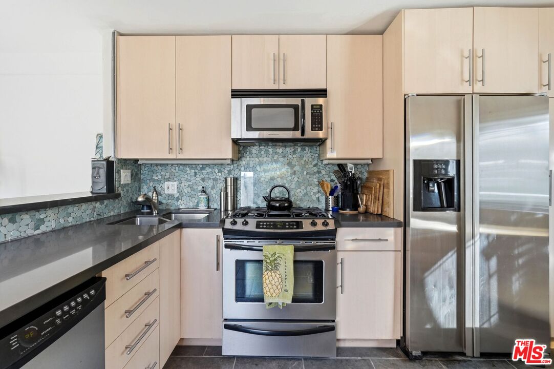 67 Paradise Cove Road Malibu, CA 90265 - Photo 12 of 45 a kitchen with cabinets stainless steel appliances and a counter space