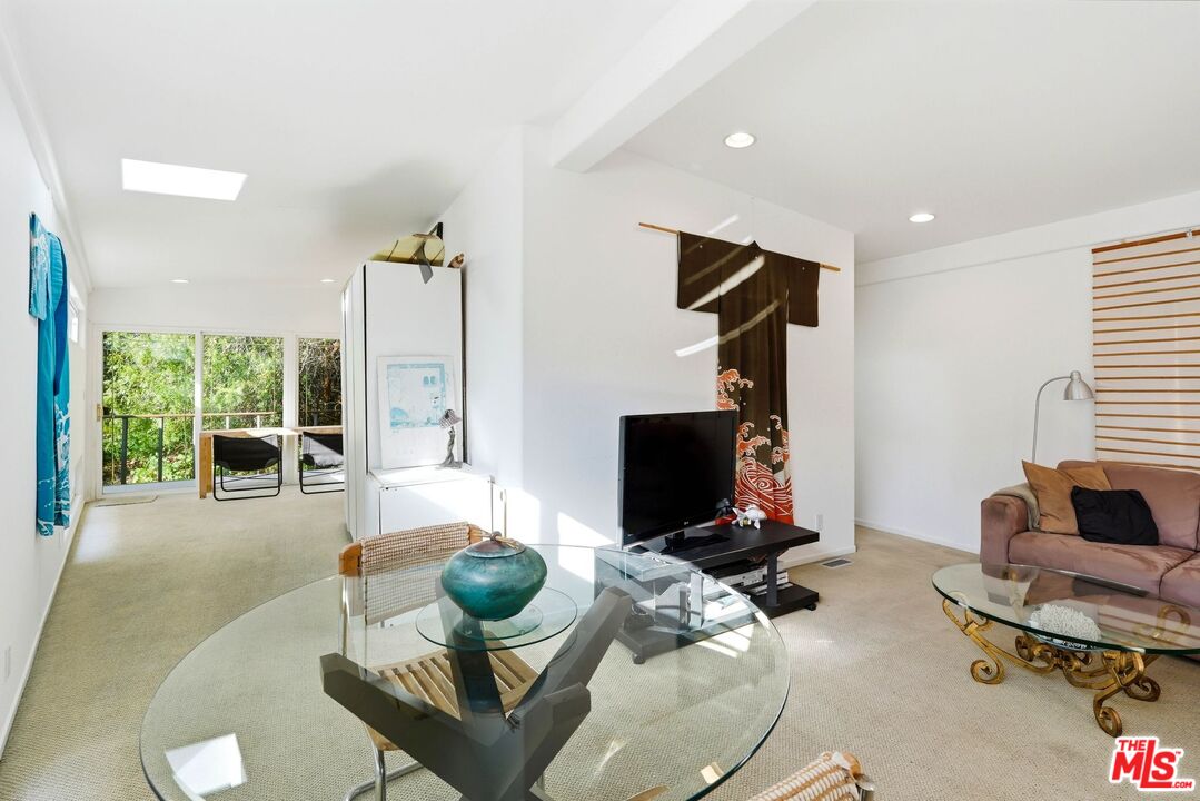 67 Paradise Cove Road Malibu, CA 90265 - Photo 8 of 45 a living room with furniture gym equipment and a large window