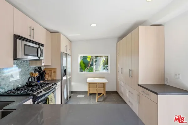a kitchen with a stove and a refrigerator