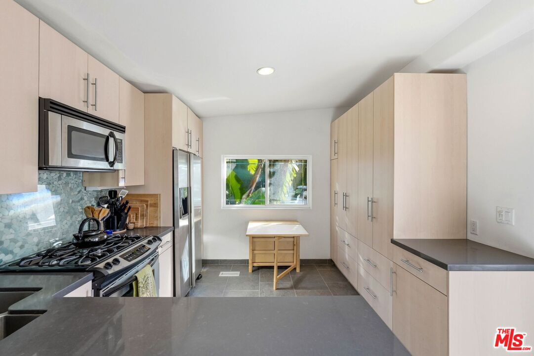 67 Paradise Cove Road Malibu, CA 90265 - Photo 10 of 45 a kitchen with a stove and a refrigerator