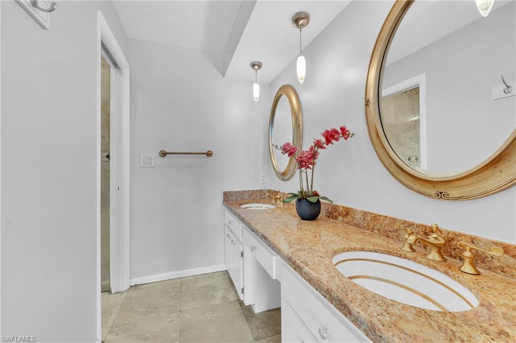 3065 50th Lane Southwest Naples, FL 34116 - Photo 15 of 31 a bathroom with a granite countertop double vanity sink and a mirror