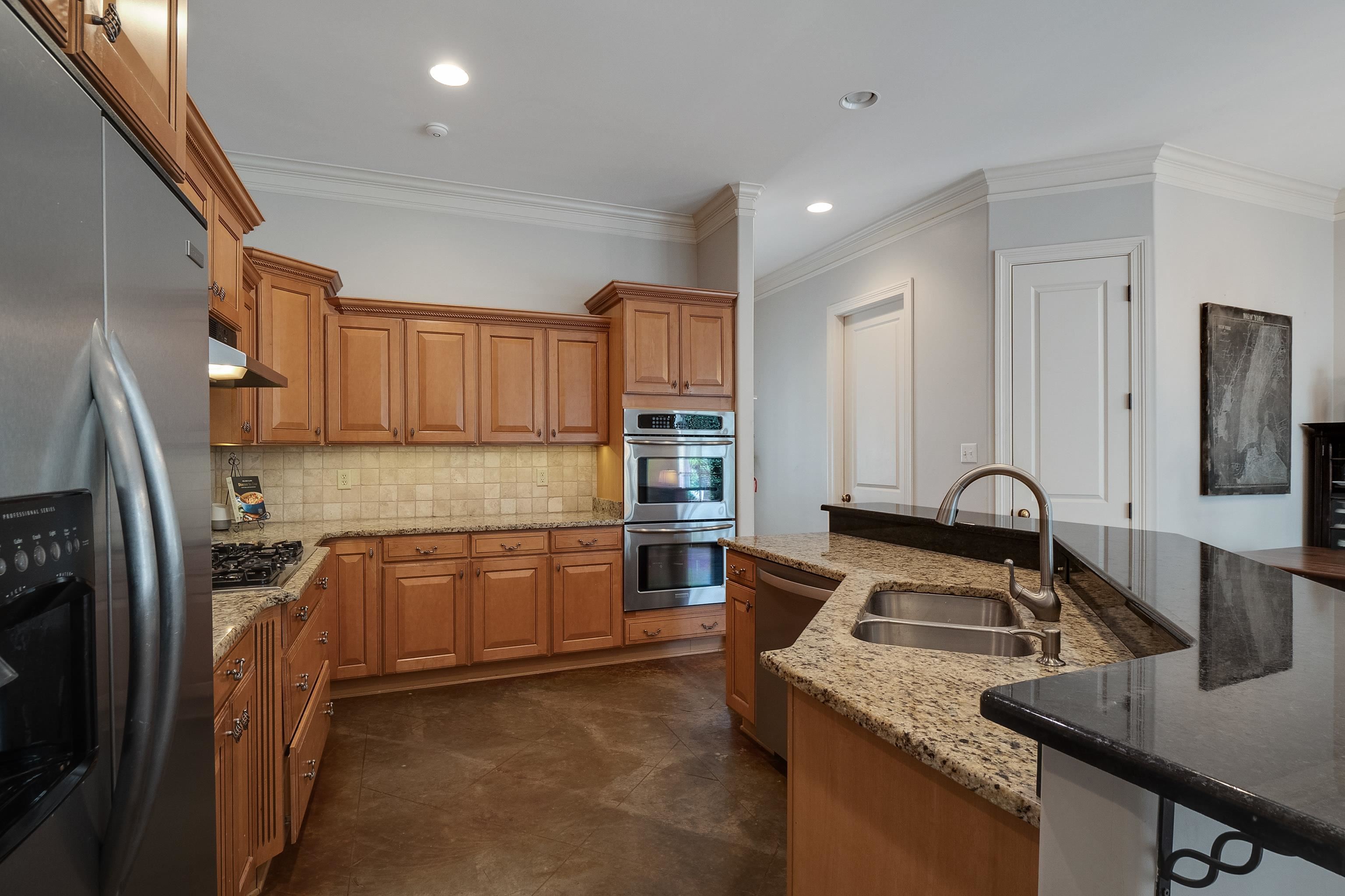 187 Ridgefield Road Memphis, TN 38111 - Photo 13 of 34 a kitchen with stainless steel appliances granite countertop a sink stove and refrigerator