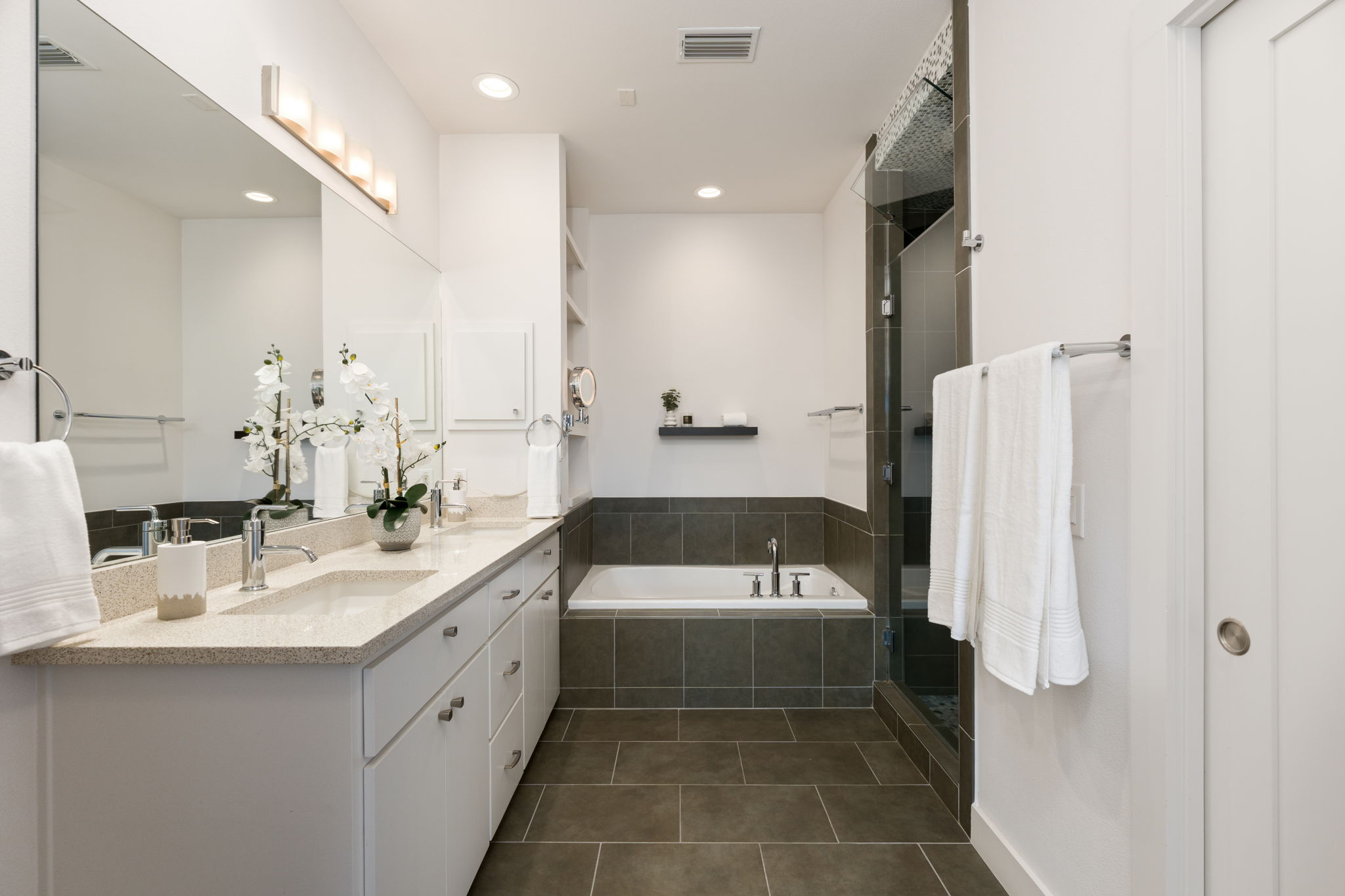 1305 Exposition Boulevard, Unit 4 Austin, TX 78703 - Photo 20 of 29 a large white bathroom with a double vanity sink a mirror and a bathtub