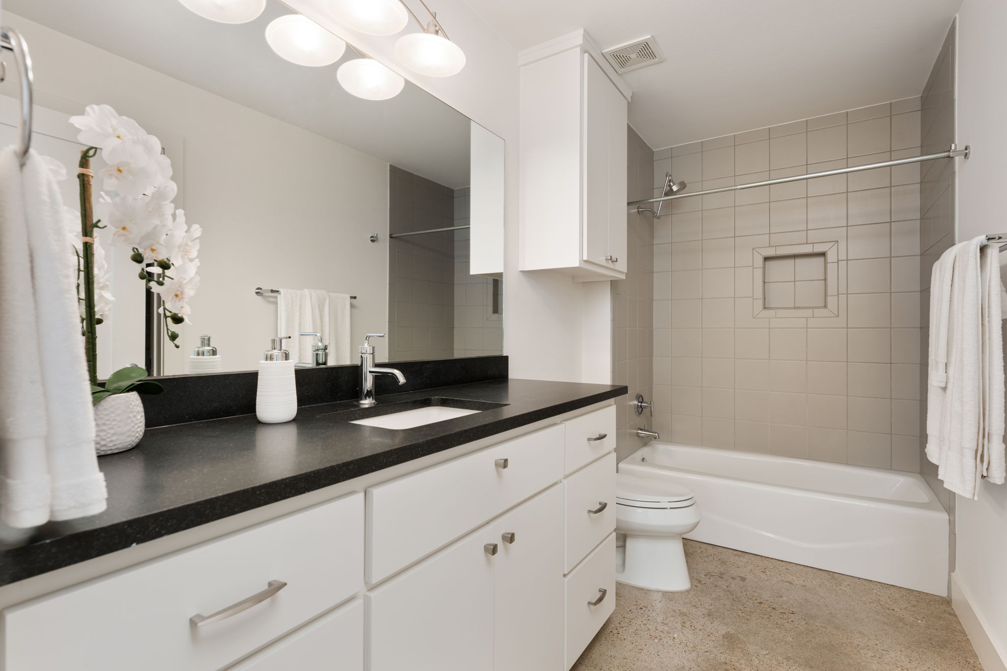 1305 Exposition Boulevard, Unit 4 Austin, TX 78703 - Photo 23 of 29 a bathroom with a granite countertop sink a toilet and bathtub