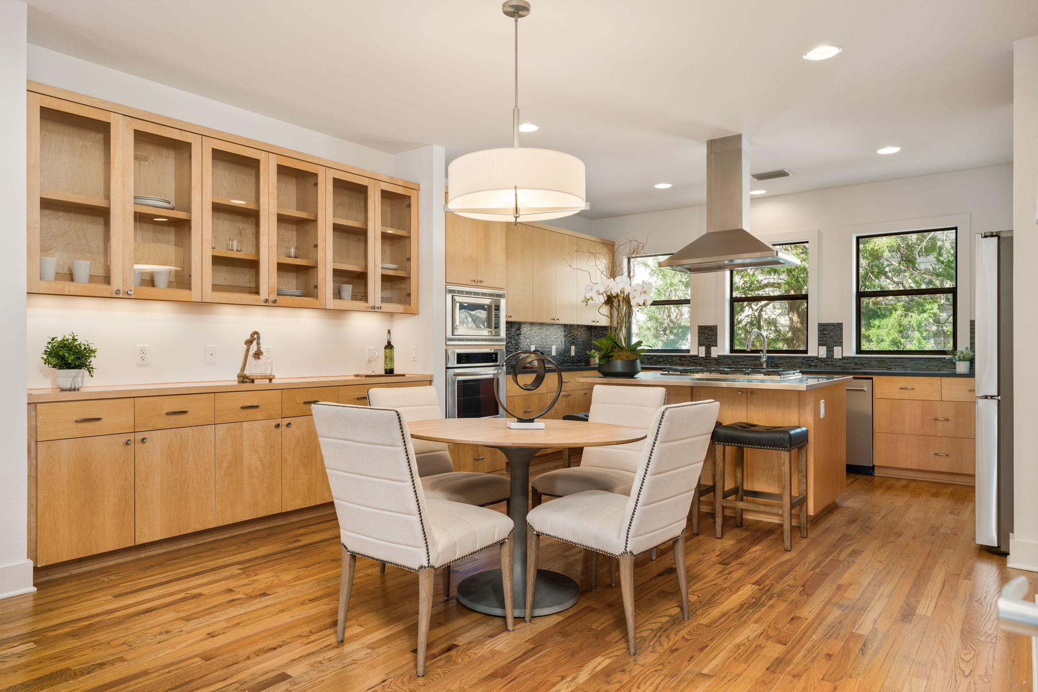 1305 Exposition Boulevard, Unit 4 Austin, TX 78703 - Photo 7 of 29 a dining hall with stainless steel appliances kitchen island granite countertop a stove a sink a dining table and chairs with wooden floor