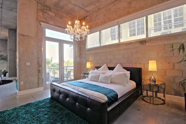 a bedroom with bed and a large window