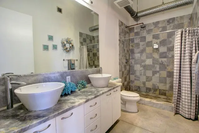 a bath room with a toilet a sink and a bath tub