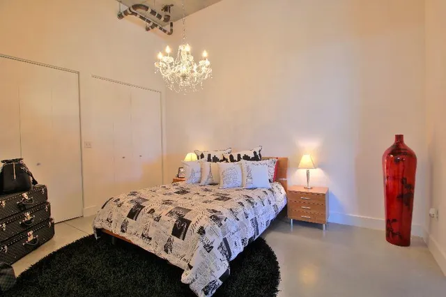 a bedroom with a bed and a chandelier