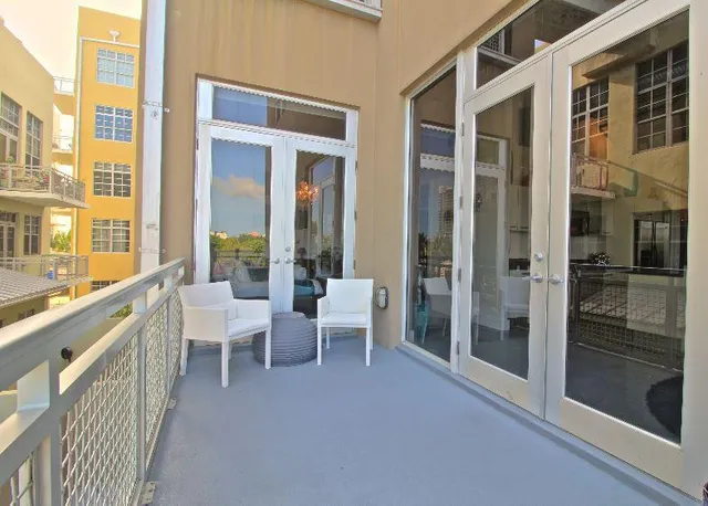 a view of a balcony with chairs and a table