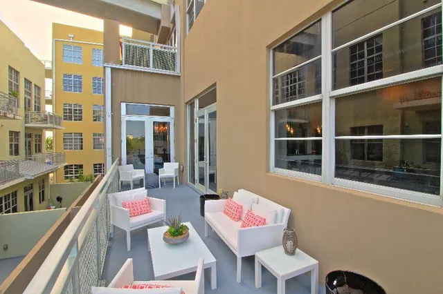 a view of a chairs and table in the balcony