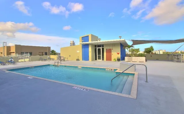 a view of a house with swimming pool and sitting area