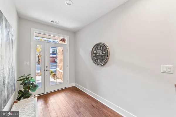a view of a hallway with wooden floor