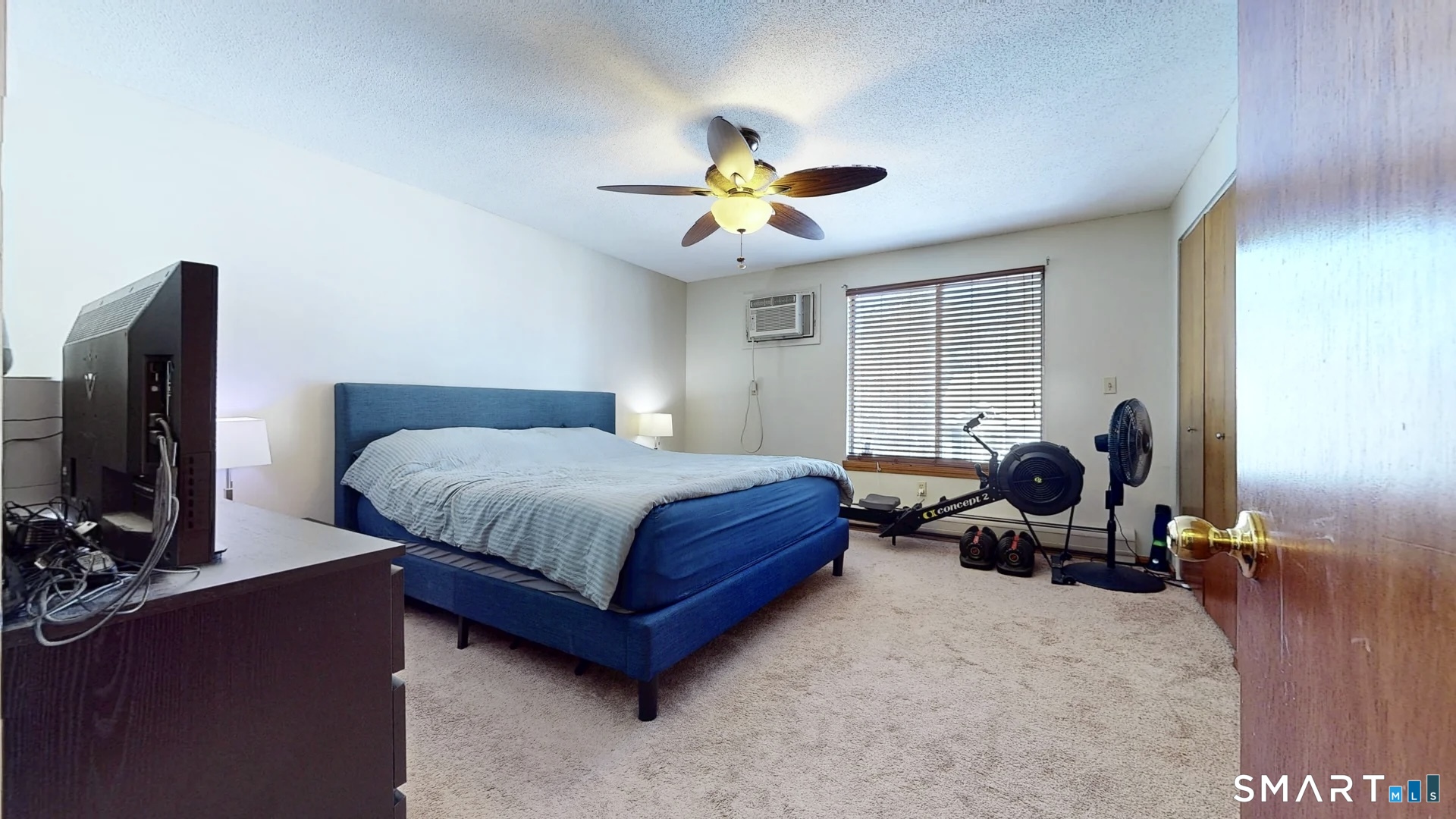 26-5 Guiel Place, Unit 8 Meriden, CT 06450 - Photo 11 of 14 a bedroom with a bed gym equipment and a window