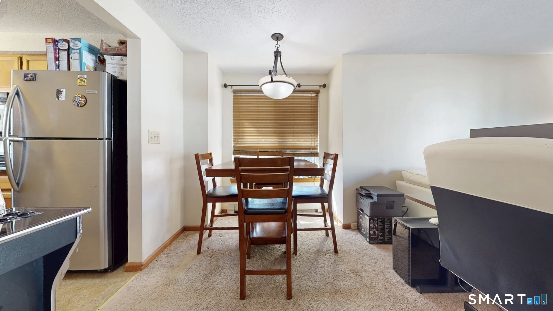 26-5 Guiel Place, Unit 8 Meriden, CT 06450 - Photo 6 of 14 a view of a dining room with furniture wooden floor and a chandelier
