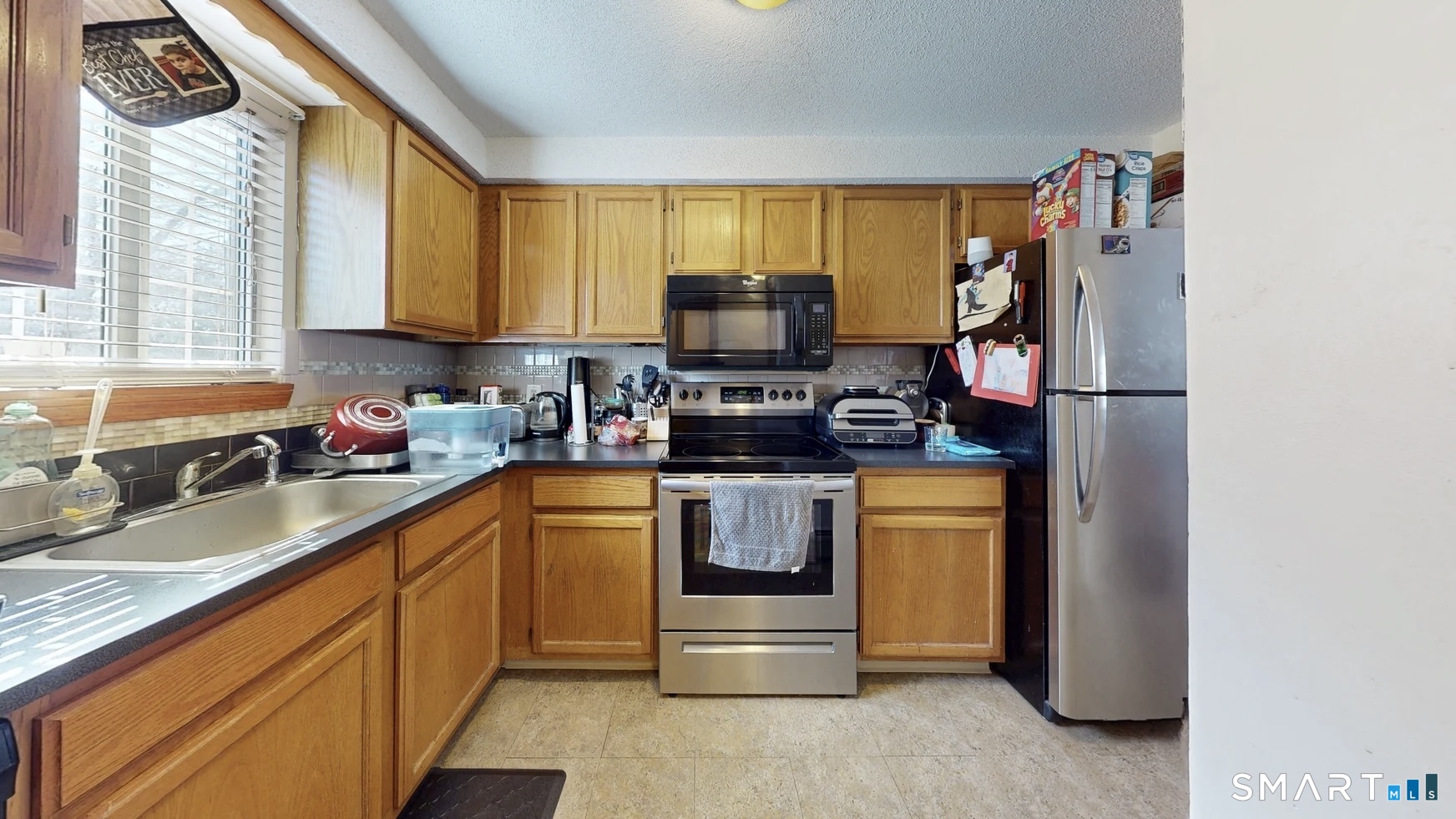 26-5 Guiel Place, Unit 8 Meriden, CT 06450 - Photo 8 of 14 a kitchen with stainless steel appliances granite countertop a stove a sink and a refrigerator