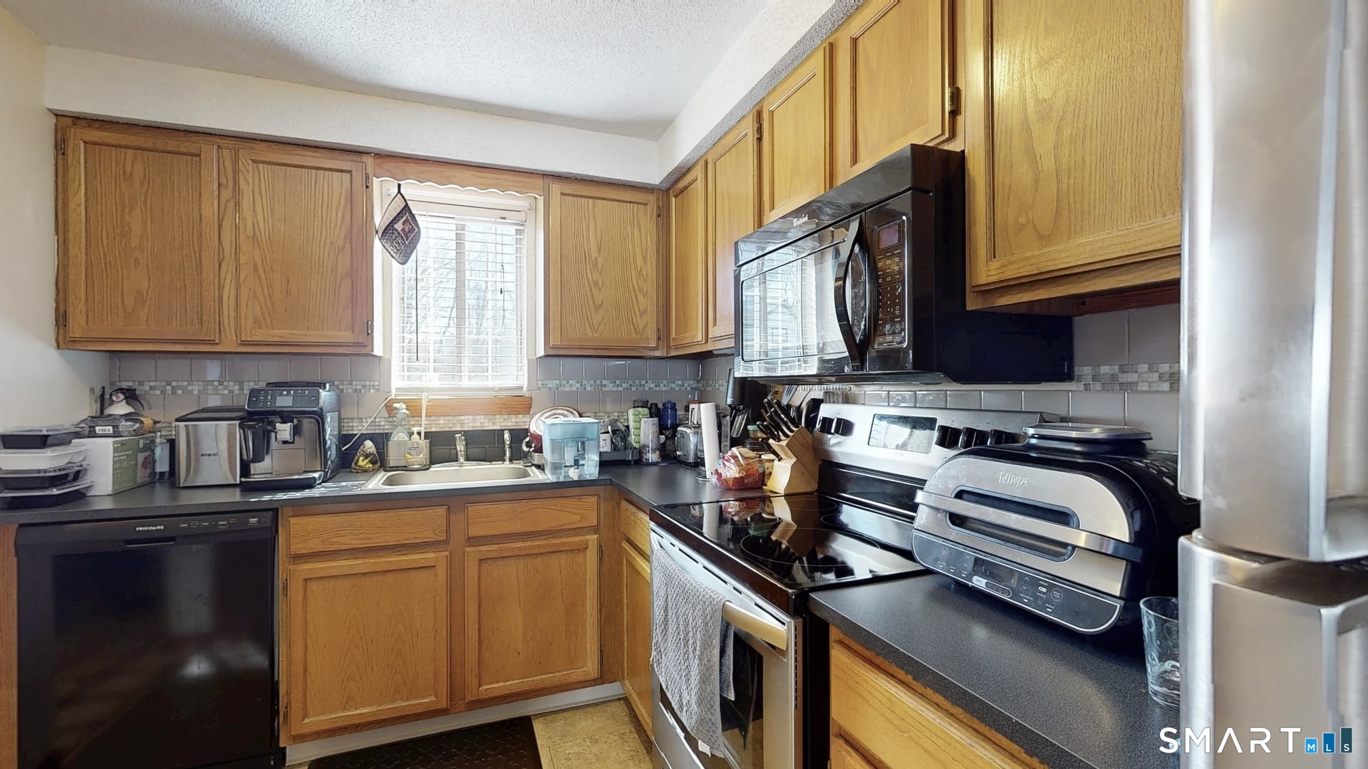 26-5 Guiel Place, Unit 8 Meriden, CT 06450 - Photo 9 of 14 a kitchen with a sink stove top oven and cabinets