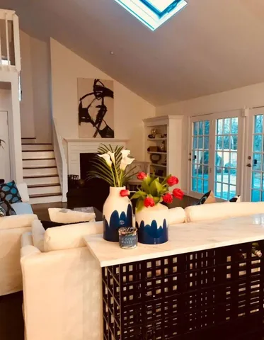 a room with a baby crib furniture and a potted plant