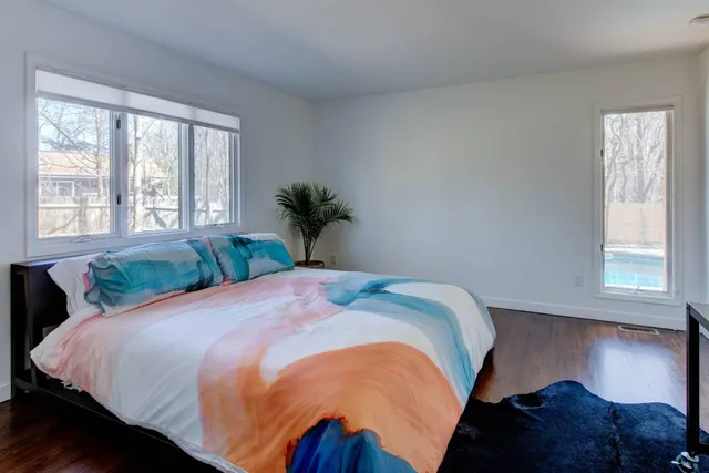 a bed sitting in a bedroom next to a window